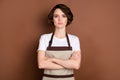 Photo of serious charming person folded arms look attentively camera on brown color background