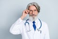 Photo of serious clever mature male doctor wear white coat arm glasses isolated grey color background