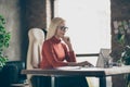 Photo of serious confident pensive woman looking into laptop comparing annual income for previous year with current one