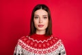 Photo of serious confident young lady wear print sweater isolated red color background