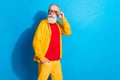 Photo of serious cool confident handsome mature man in glasses look copyspace go walk isolated on blue color background Royalty Free Stock Photo