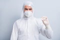 Photo of serious guy expert doc virology hold thermometer border airport control passengers arrivals wear face mask suit