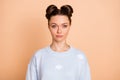 Photo of serious nice brunette lady wear light blue sweater isolated on pastel beige color background