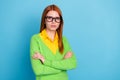 Photo of serious orange hairdo young teacher lady crossed arms wear spectacles green sweater isolated on blue color