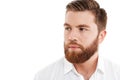 Serious young bearded man standing over white wall Royalty Free Stock Photo