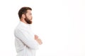 Serious young bearded man standing over white wall Royalty Free Stock Photo