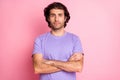 Photo of serious young man crossed arms confident look wear purple t-shirt isolated on pink color background Royalty Free Stock Photo