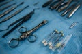 Photo of a set of steril dentistry tools or instruments lying on a light blue table