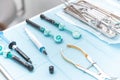 Photo of a set of steril dentistry tools or instruments lying on a table.