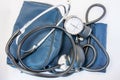 Photo set of stethoscope and arm sphygmomanometer with carrying bag or case. On white background is black stethoscope with sphygmo