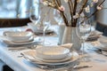 Photo of a set table with elements of Scandinavian design, white dishes, transparent wine glasses, cutlery, Royalty Free Stock Photo