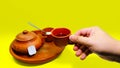 photo of a set of traditional clay teapots and teacups and a man's hand holding a cup Royalty Free Stock Photo