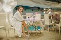 photo of a sexy beautiful reddish woman in white bath gown relaxing in the fito bar of a spa centre