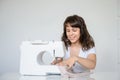 Photo of a sexy brunette working at the sewing machine Royalty Free Stock Photo