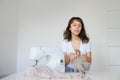 Photo of a sexy brunette working at the sewing machine and playing with a gray kitten Royalty Free Stock Photo