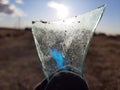 photo of a shard of glass against the sun