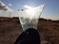 photo of a shard of glass against the sun