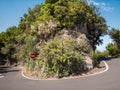 Image of sharp hairpin road turn going around high cliff in mountains