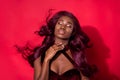 Photo of shine dreamy afro american young woman enjoy wind fly hair isolated on red color background
