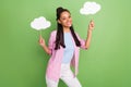 Photo of shiny charming dark skin woman dressed striped shirt holding two mind clouds empty space isolated green color