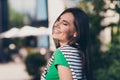 Photo of shiny dreamy girl dressed green top enjoying sunshine closed eyes outdoors urban town park Royalty Free Stock Photo