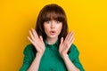 Photo of shiny impressed lady wear green shirt big eyes rising arms hands isolated yellow color background Royalty Free Stock Photo