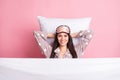 Photo of shiny relaxing young lady nightwear mask covering blanket lying pillow arms behind head isolated pink color