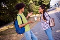 Photo of shiny sweet boyfriend girlfriend wear casual outfits rucksack smiling talking drinking milk cocktail outside Royalty Free Stock Photo