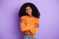 Photo of shiny sweet dark skin lady wear orange shirt embracing herself isolated violet color background Royalty Free Stock Photo