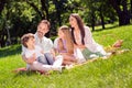 Photo of shiny sweet family wear casual clothes smiling having picnic sitting plaid blanket outdoors urban city park Royalty Free Stock Photo