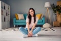 Photo of shiny sweet young girl wear pink t-shirt smiling sitting floor legs crossed having rest relaxing indoors home Royalty Free Stock Photo