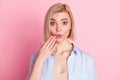 Photo of shocked amazed guilty young woman hold hand mouth tell secret isolated on pastel pink color background