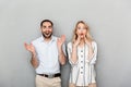 Photo of shocked couple in casual clothing smiling and looking at camera Royalty Free Stock Photo