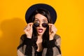 Photo of shocked crazy lady take off eyeglasses open mouth wear hat plaid jacket yellow color background