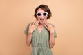 Photo of shocked excited happy young woman hand face wear sunglass sale season isolated on beige color background Royalty Free Stock Photo