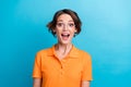 Photo of shocked excited lady wear orange t-shirt spectacles open mouth isolated blue color background