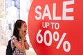 Photo shocked girl standing of shop windows with a sale,shocking price