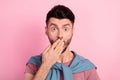 Photo of shocked guilty young man hold cover hand mouth secret mistake isolated on pink color background