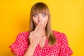 Photo of shocked guilty young woman hold hand mouth afraid tell speak secret isolated on yellow color background