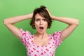 Photo of shocked pretty lady wear pink blouse arms head open mouth isolated green color background Royalty Free Stock Photo