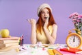 Photo of shocked student girl pointing finger sitting with exercise books Royalty Free Stock Photo