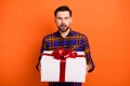 Photo of shocked unsatisfied person hands hold giftbox open mouth staring isolated on orange color background