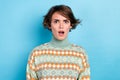 Photo of shocked unsatisfied young girl open mouth staring cant believe isolated on blue color background