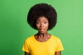 Photo of shocked young afro american woman wear yellow t-shirt stare isolated on green color background