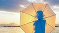 Photo shoot background. Stylish hipster, little boy in hat with umbrella on seashore. Silhouette of a man back view on Royalty Free Stock Photo