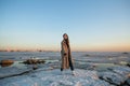 Photo shoot woman on the shore of the Gulf of Finland in St. Petersburg in winter