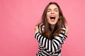 Photo shot of cute attractive pretty young delightful happy brunette woman wearing casual striped longsleeve isolated