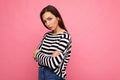 Photo shot of cute attractive pretty young sad sorrowful brunette woman wearing casual striped longsleeve isolated over