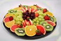 a collection of healthy and fresh fruits in a black plate Royalty Free Stock Photo