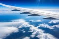 Wing of an Airplane Flying Above Clouds Royalty Free Stock Photo